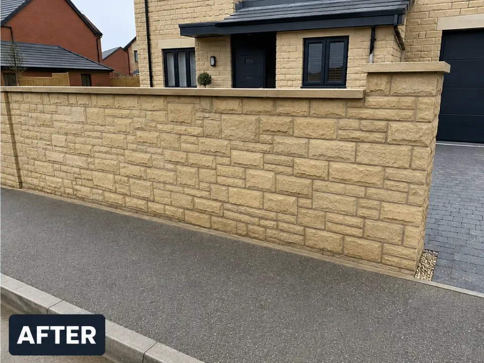 The same stone boundary wall cleaned to an even, warm natural tone