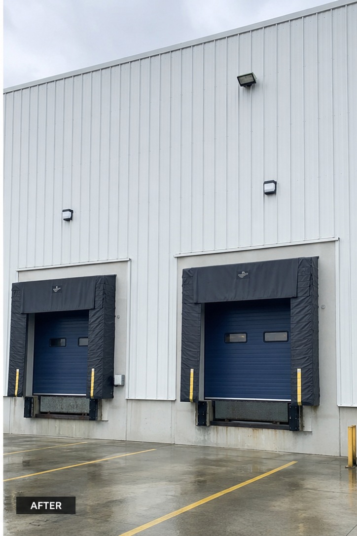 The same industrial cladding and loading bay surround cleaned to an even white finish